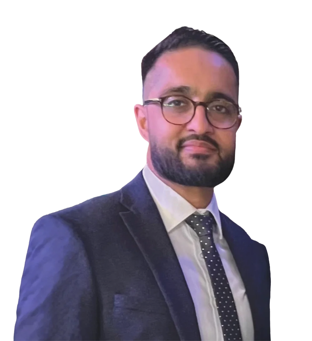 Professional headshot of a man with a beard and glasses, wearing a suit and patterned tie.
